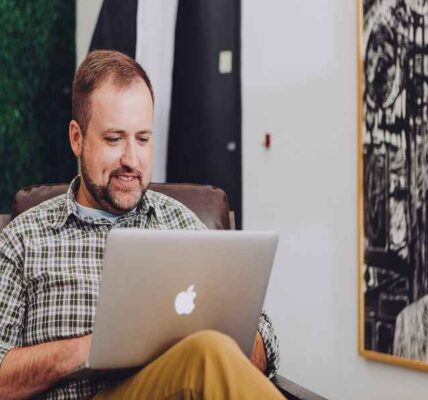 Person using a laptop with a thoughtful expression, trying to understand changes related to PC updates